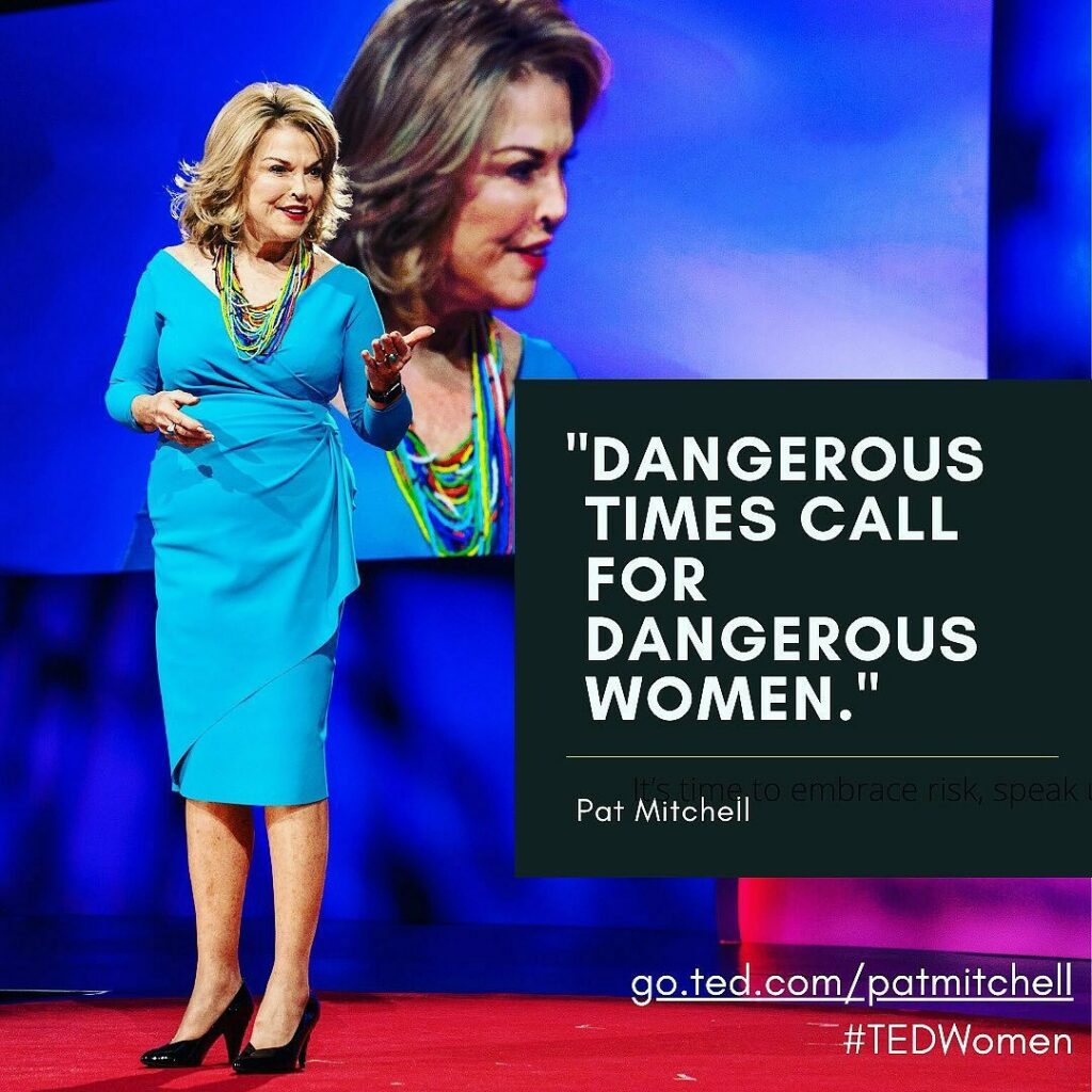 Pat Mitchell speaking on stage at TEDWomen wearing a bright blue dress, with overlay text reading "Dangerous times call for dangerous women."